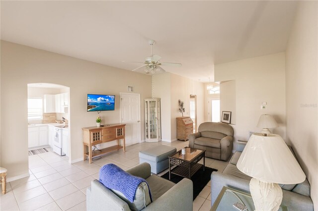 living room with ceiling fan, a healthy amount of sunlight, and light tile patterned floors