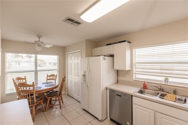 kitchen featuring white fridge with ice dispenser, dishwasher, sink, white cabinetry, and ceiling fan