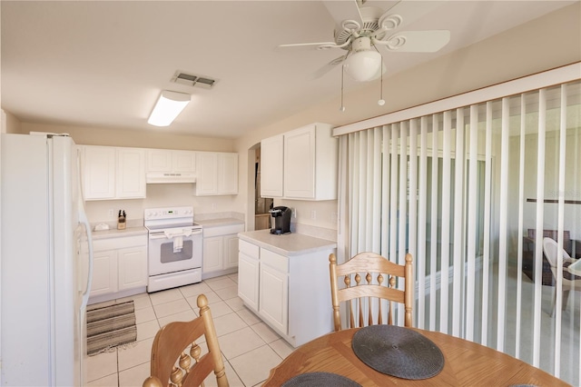 kitchen with light tile patterned floors, white cabinets, white appliances, and ceiling fan