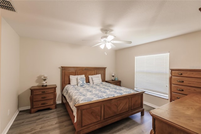 bedroom with dark hardwood / wood-style floors and ceiling fan