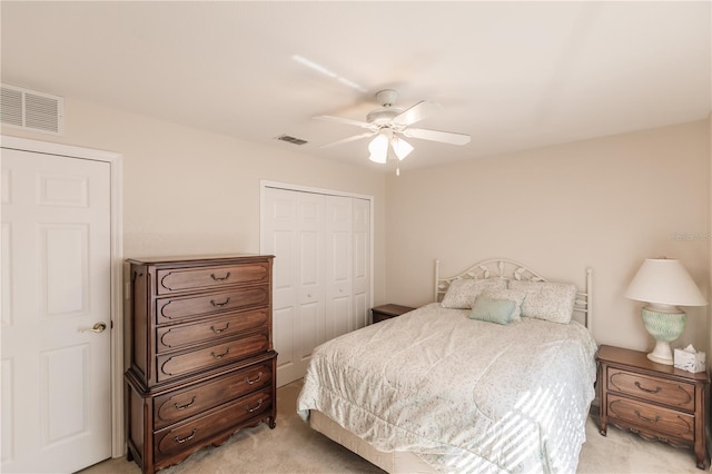 bedroom featuring light carpet, a closet, and ceiling fan