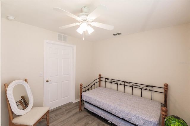 bedroom with ceiling fan and hardwood / wood-style floors