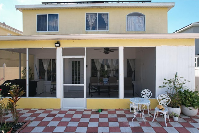 back of property with a patio area, ceiling fan, and a sunroom