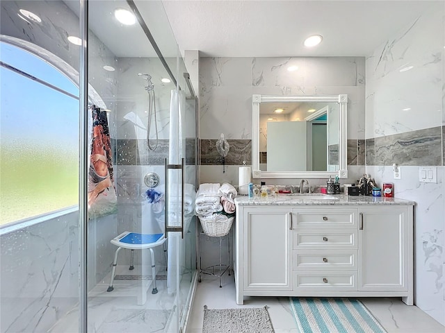 bathroom featuring vanity, tile walls, and tiled shower