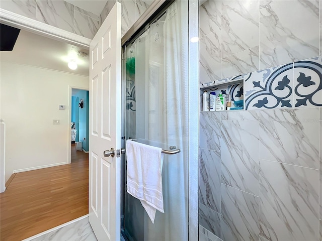 bathroom with a shower with door