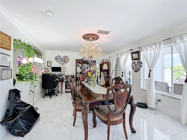 dining area featuring ornamental molding and an inviting chandelier