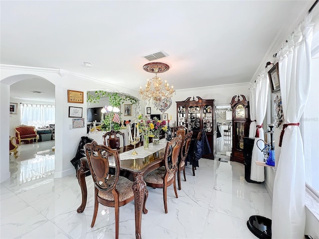 dining area with ornamental molding and an inviting chandelier