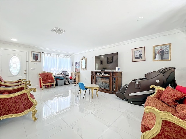 living room with ornamental molding and a fireplace