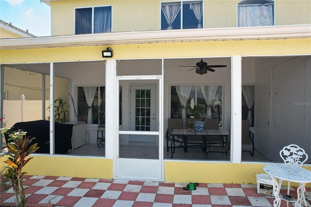 view of patio featuring ceiling fan, a sunroom, and area for grilling