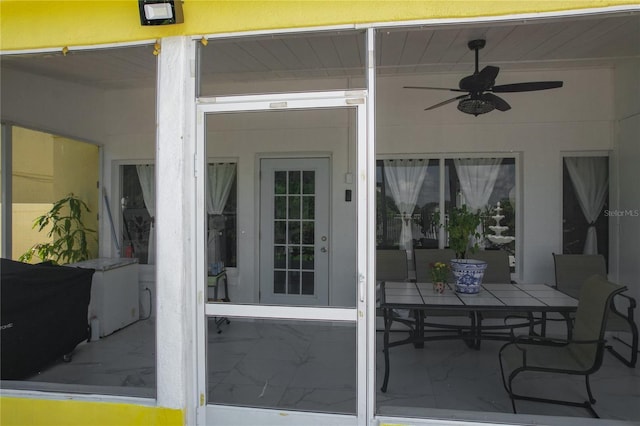 exterior space with ceiling fan and a patio