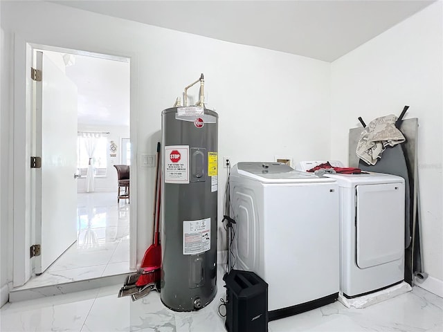 laundry room featuring water heater and washing machine and clothes dryer