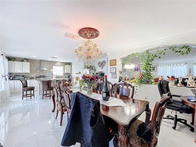 dining area featuring a chandelier and crown molding