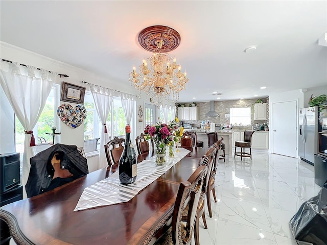 dining space featuring ornamental molding and a chandelier