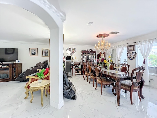 dining space featuring ornamental molding and a chandelier