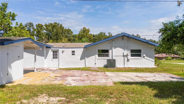 back of house with a patio area, a yard, and cooling unit