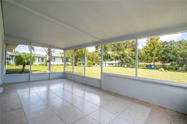 unfurnished sunroom featuring lofted ceiling