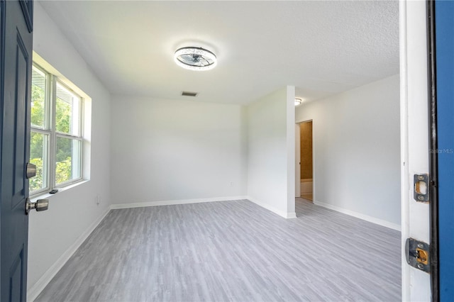 unfurnished room with wood-type flooring