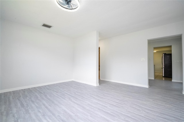 spare room featuring light hardwood / wood-style flooring