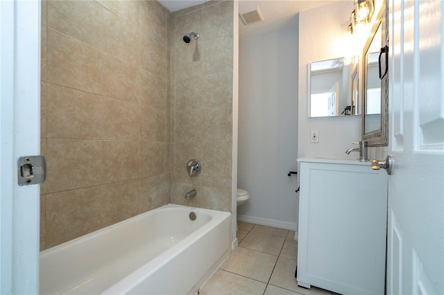 full bathroom featuring toilet, tiled shower / bath combo, vanity, and tile patterned floors