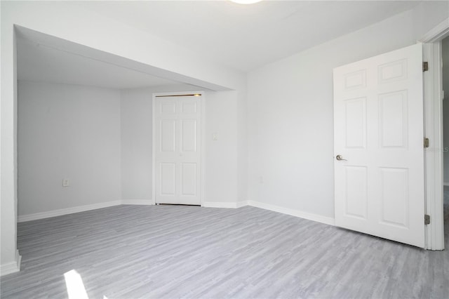 spare room featuring light wood-type flooring