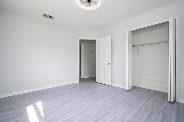 unfurnished bedroom featuring a closet and light hardwood / wood-style floors