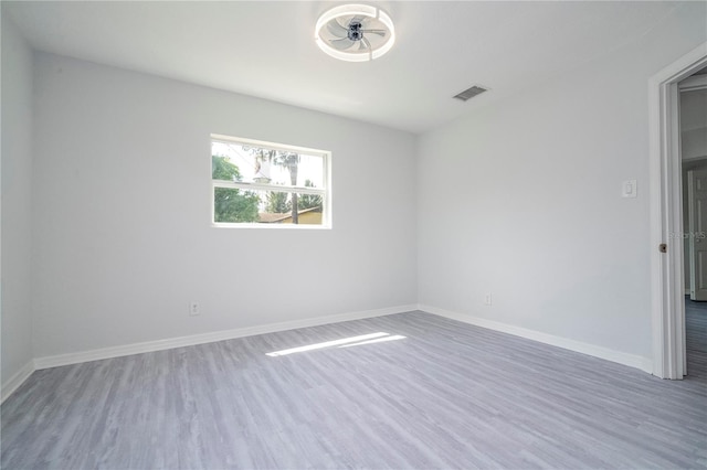 empty room with hardwood / wood-style flooring and ceiling fan