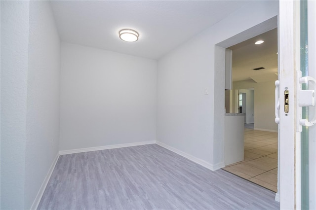 spare room featuring light hardwood / wood-style floors