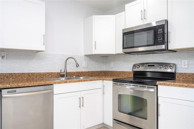 kitchen with white cabinets, stainless steel appliances, sink, and backsplash