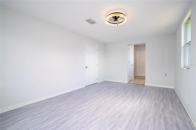 spare room with light wood-type flooring