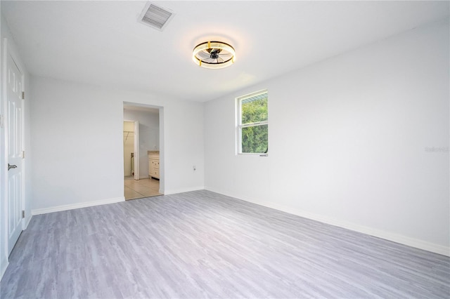 spare room featuring light wood-type flooring