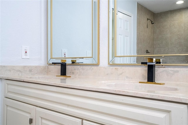 bathroom featuring vanity and a tile shower