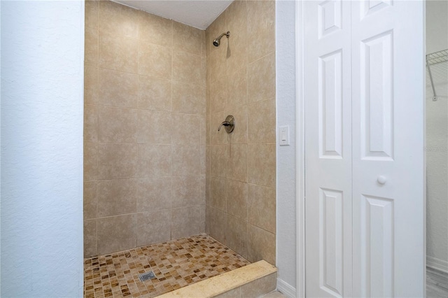 bathroom with tiled shower