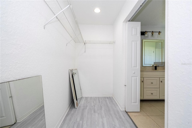 spacious closet featuring light hardwood / wood-style floors