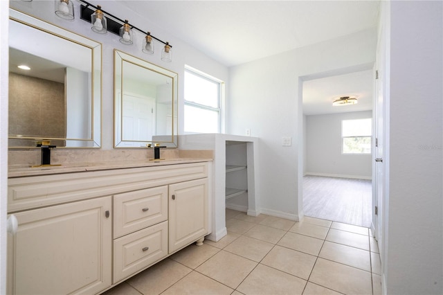 bathroom with vanity, a healthy amount of sunlight, and tile patterned floors