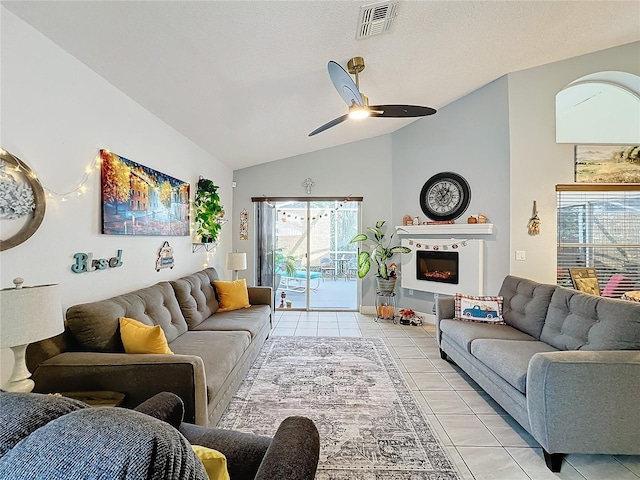 tiled living room featuring vaulted ceiling and ceiling fan