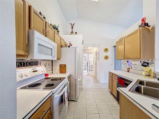 kitchen featuring white appliances, vaulted ceiling, light tile patterned floors, and sink