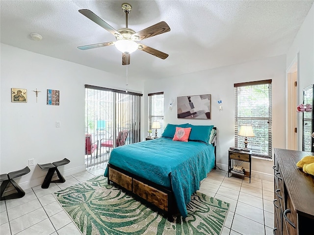 bedroom featuring a textured ceiling, light tile patterned floors, ceiling fan, and access to exterior