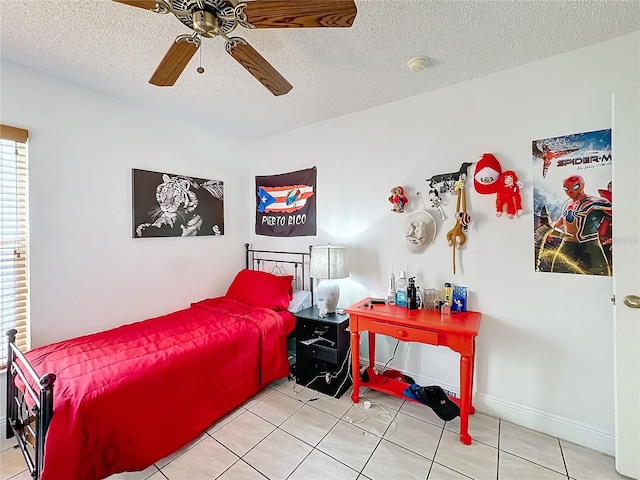 tiled bedroom with ceiling fan and a textured ceiling