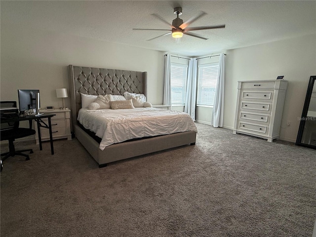 bedroom featuring ceiling fan, dark carpet, and a textured ceiling