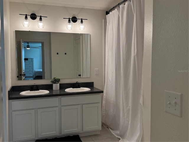 bathroom featuring a textured ceiling, tile patterned floors, and vanity