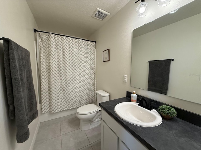 full bathroom featuring toilet, a textured ceiling, shower / tub combo with curtain, tile patterned flooring, and vanity