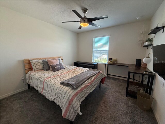 carpeted bedroom featuring a textured ceiling and ceiling fan