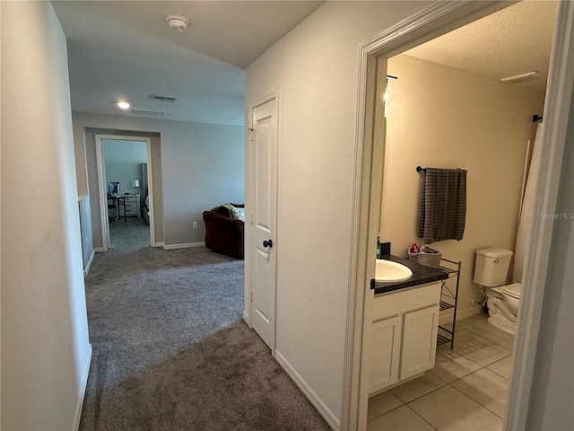 2346 Upland Ln, Apopka, FL 32712 - hallway featuring baseboards, light carpet, and a sink