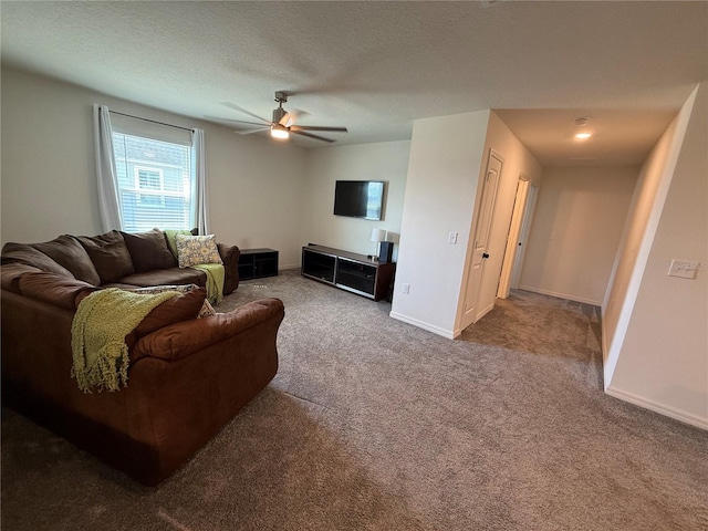 carpeted living room featuring a textured ceiling and ceiling fan