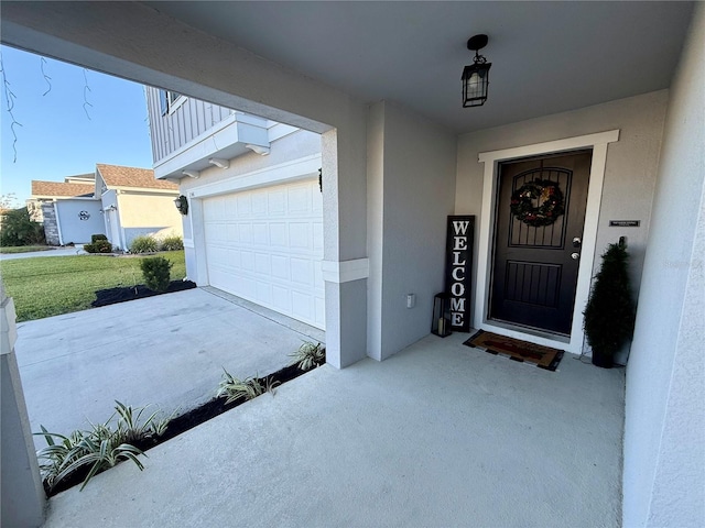 doorway to property with a balcony and a garage