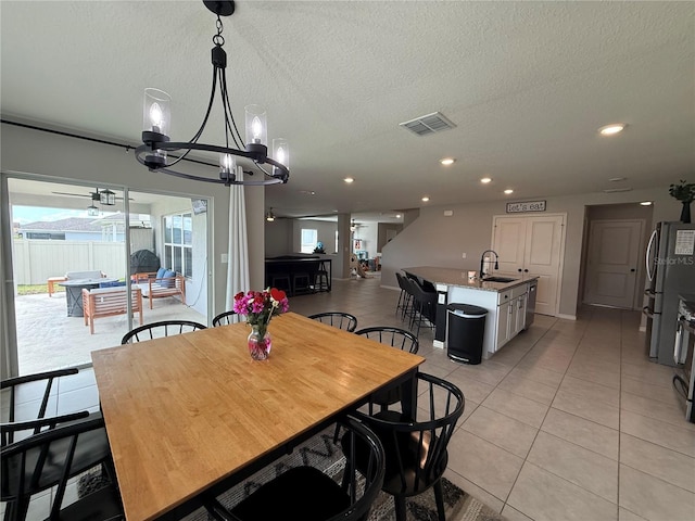 2346 Upland Ln, Apopka, FL 32712 - dining space featuring light tile patterned flooring, a textured ceiling, a chandelier, and recessed lighting