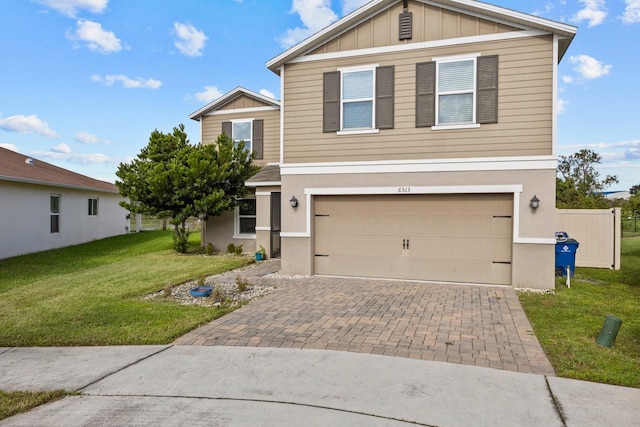 view of front facade with a front yard and a garage