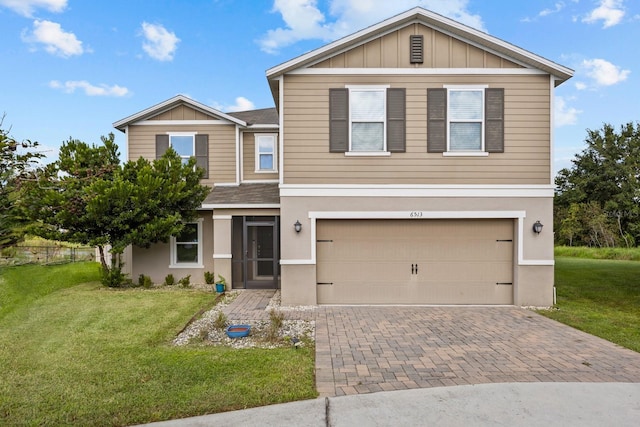 view of front of home featuring a front yard and a garage