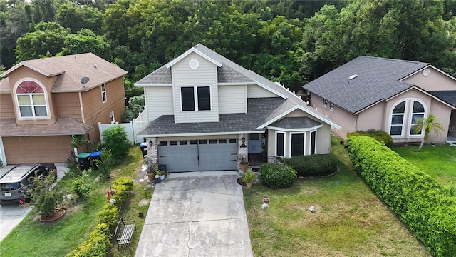 view of front facade with a garage and a front lawn