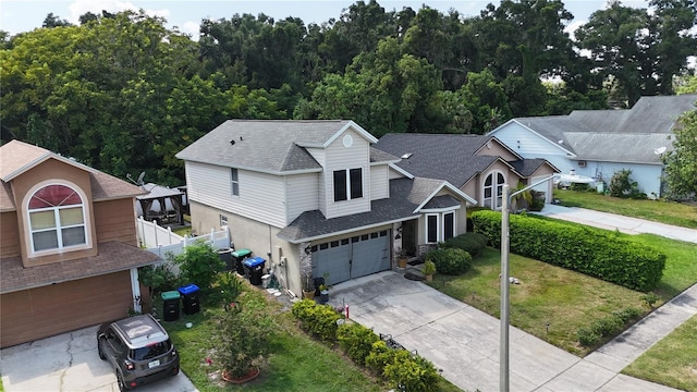 view of front of property with a front yard and a garage